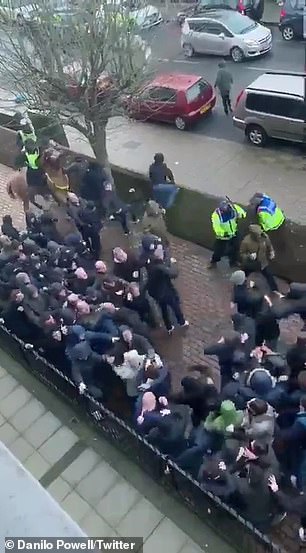The two sets of fans fight before being broken up by police