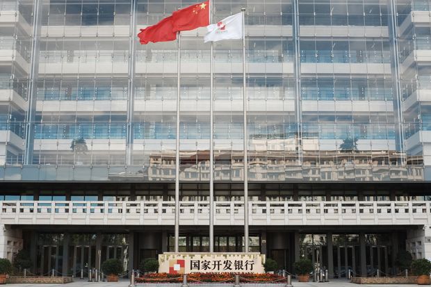 A Chinese flag flutters at the Beijing headquarters of China Development Bank, which has made...