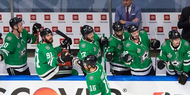 Dallas Stars center Joe Pavelski (16) celebrates his goal against the Tampa Bay Lightning with teammates on the bench during the first period of Game 4 of the NHL hockey Stanley Cup Final, Friday, Sept. 25, 2020, in Edmonton, Alberta. (Jason Franson/The Canadian Press via AP)