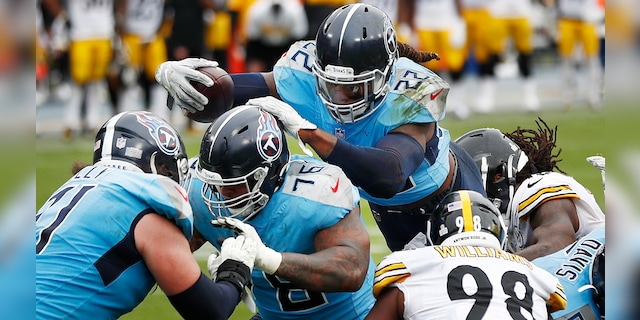 Tennessee Titans running back Derrick Henry (22) follows the blocking of offensive guard Rodger Saffold (76) as Henry scores a touchdown against the Pittsburgh Steelers in the second half of an NFL football game Sunday, Oct. 25, 2020, in Nashville, Tenn. (AP Photo/Wade Payne)