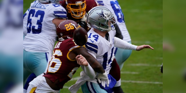 Washington Football Team strong safety Landon Collins (26) knocks the ball of the hands of Dallas Cowboys quarterback Andy Dalton (14) during the first half of an NFL football game, Sunday, Oct. 25, 2020, in Landover, Md. (AP Photo/Susan Walsh)
