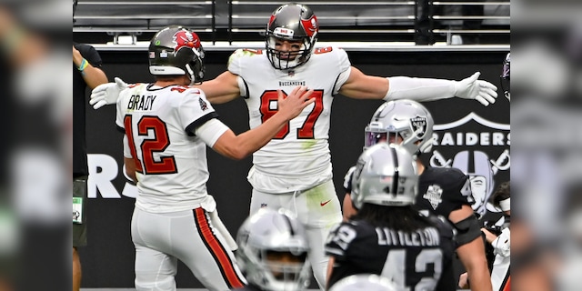 Tampa Bay Buccaneers tight end Rob Gronkowski celebrates with quarterback Tom Brady, left, after Gronkowski scored a touchdown against the Las Vegas Raiders during the first half of an NFL football game, Sunday, Oct. 25, 2020, in Las Vegas. (AP Photo/David Becker)