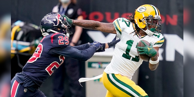 Green Bay Packers wide receiver Davante Adams (17) runs with the ball as Houston Texans cornerback Phillip Gaines (29) defends during the first half of an NFL football game Sunday, Oct. 25, 2020, in Houston. (AP Photo/Sam Craft)