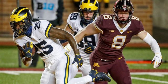 Michigan running back Hassan Haskins (25) rushes past tight end Carter Selzer (89) and Thomas Rush (8) for a touchdown in the second quarter of an NCAA college football game Saturday, Oct. 24, 2020, in Minneapolis. (AP Photo/Bruce Kluckhohn)