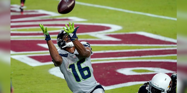 Seattle Seahawks wide receiver Tyler Lockett (16) pulls in a touchdown pass as Arizona Cardinals cornerback Dre Kirkpatrick (20) defends during the second half of an NFL football game, Sunday, Oct. 25, 2020, in Glendale, Ariz. (AP Photo/Ross D. Franklin)