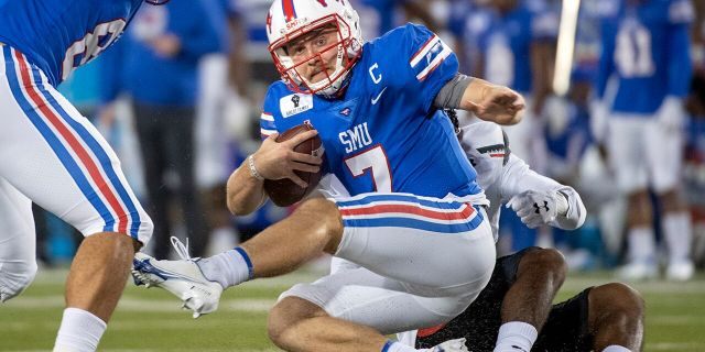 SMU quarterback Shane Buechele (7) is tackled by Cincinnati linebacker Jarrell White (8) for a loss during the first half of an NCAA college football game Saturday, Oct. 24, 2020, in Dallas. (AP Photo/Jeffrey McWhorter)