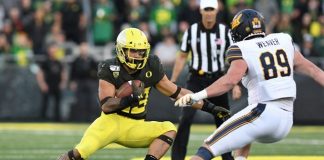 Running back tackles fan who ran on the field, offers him ice cream EUGENE, OR - OCTOBER 05: Oregon Ducks RB Cyrus Habibi-Likio (33) runs the ball against California Golden Bears ILB Evan Weaver (89) during a college football game between the Cal Bears and Oregon Ducks at Autzen Stadium in Eugene, Oregon. (Photo by Brian Murphy/Icon Sportswire via Getty Images)