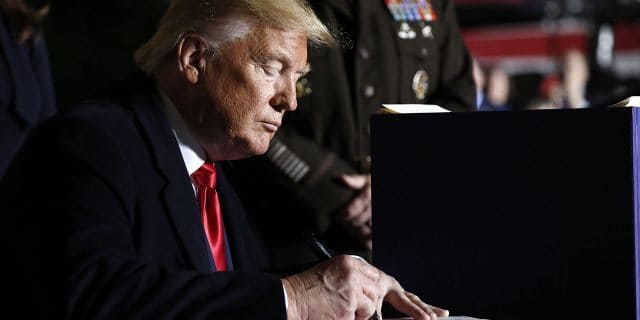 Trump signs $1.4T spending bill that includes Space Force, avoids shutdown President Donald Trump signs the National Defense Authorization Act for Fiscal Year 2020 at Andrews Air Force Base, Md., Friday, Dec. 20, 2019. (AP Photo/Andrew Harnik)